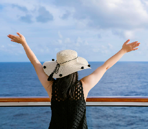 Mujer disfrutando la vista al océano desde un crucero Crown Princess en vacaciones